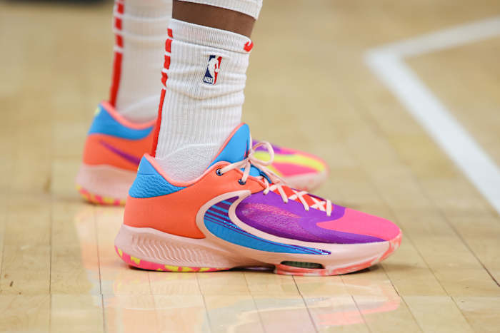 View of purple and orange Nike Zoom Freak shoes.